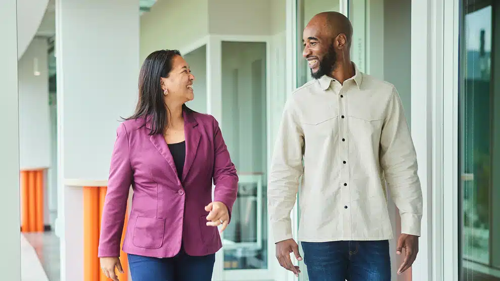 man and woman conversing outside office building