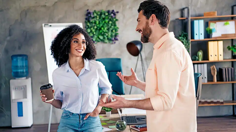 man and woman talking in an office setting