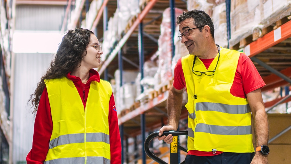 two people conversing in a manufacturing setting