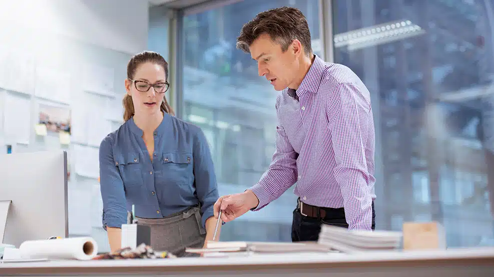 two colleagues chatting at work